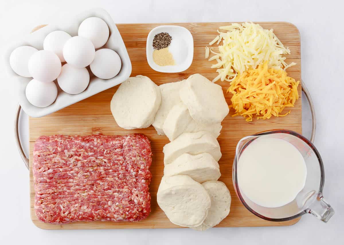 Breakfast casserole with biscuit ingredients on counter. 