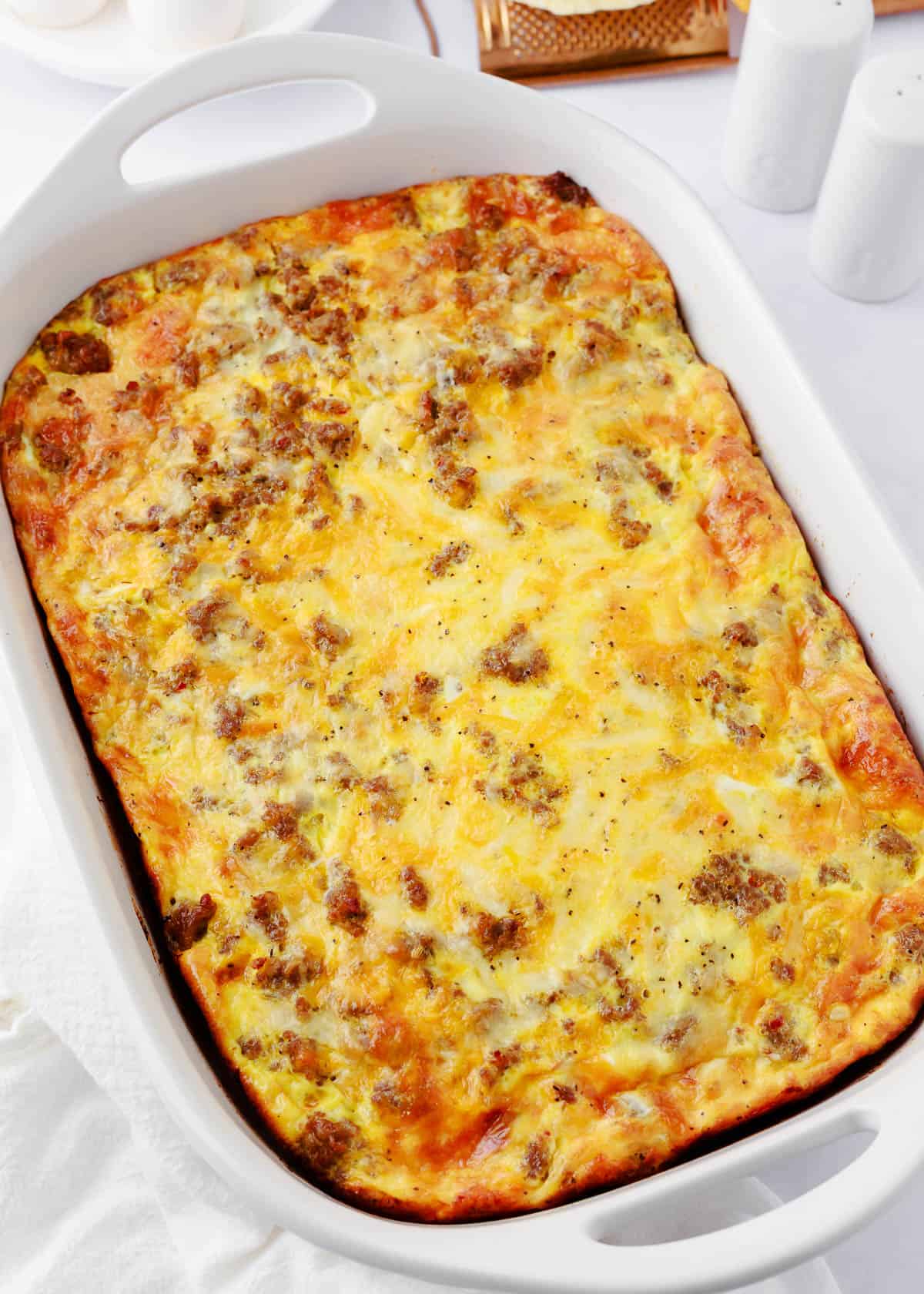 Breakfast Casserole with Biscuits in a white baking dish. 