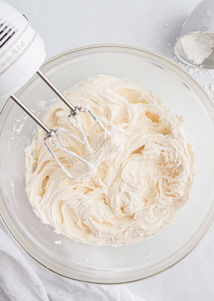 Buttercream whipped in a glass bowl.