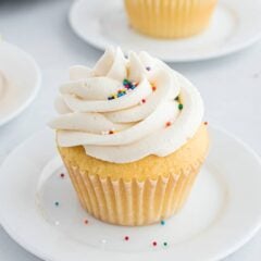 Buttercream frosting topped on a vanilla cupcake.