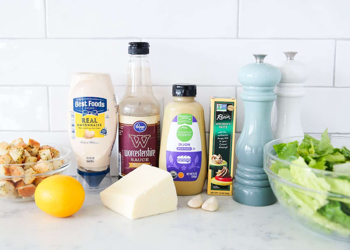 Caesar salad ingredients on a marble counter.