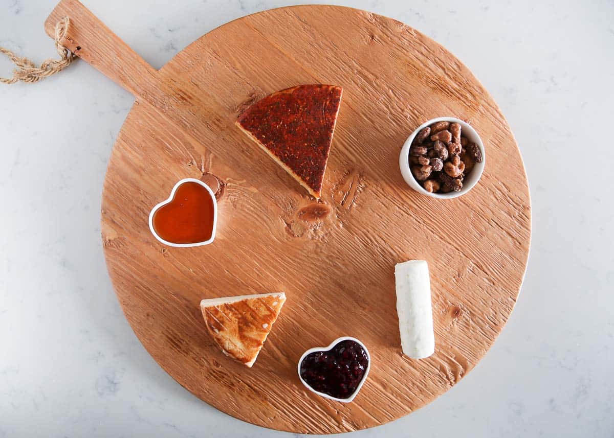 Charcuterie ingredients on a board.