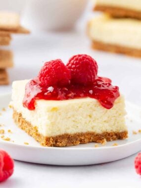 Cheesecake bars with fresh raspberries on top.