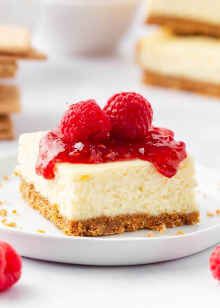 Cheesecake bars with fresh raspberries on top.