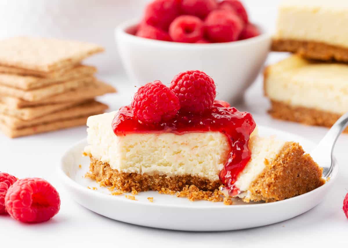 Cheesecake bars with raspberries on top.