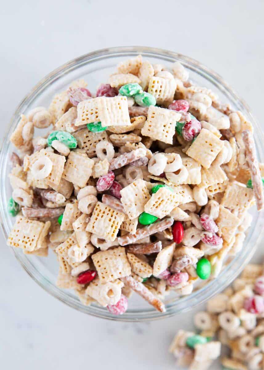 Christmas chex mix in glass bowl.