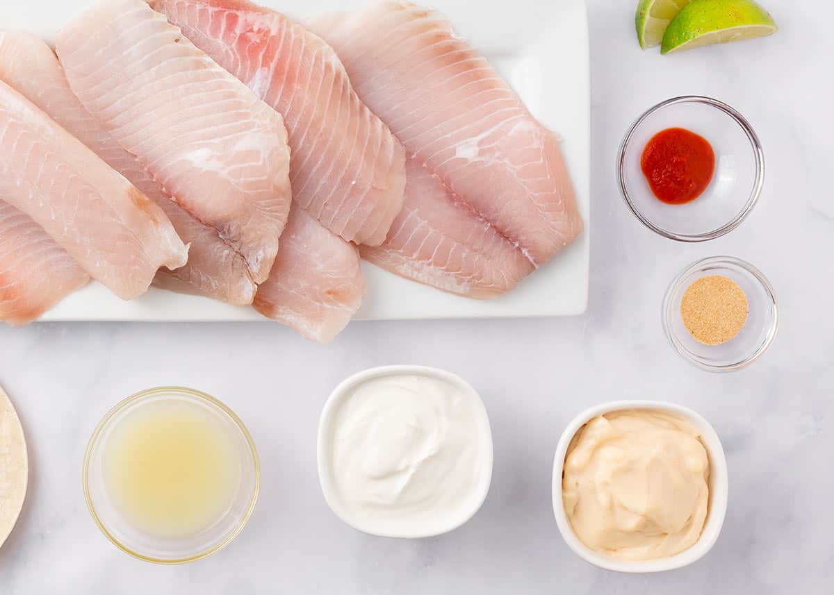 Fish taco sauce ingredients on counter.