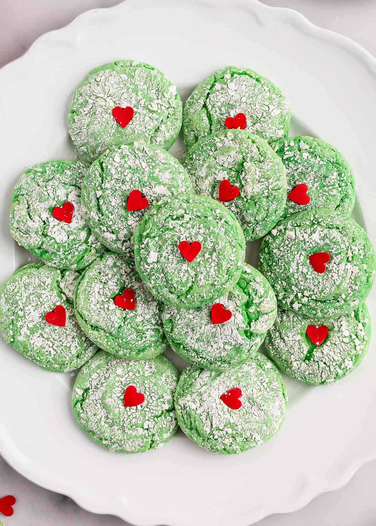 Grinch cookies on a white plate.