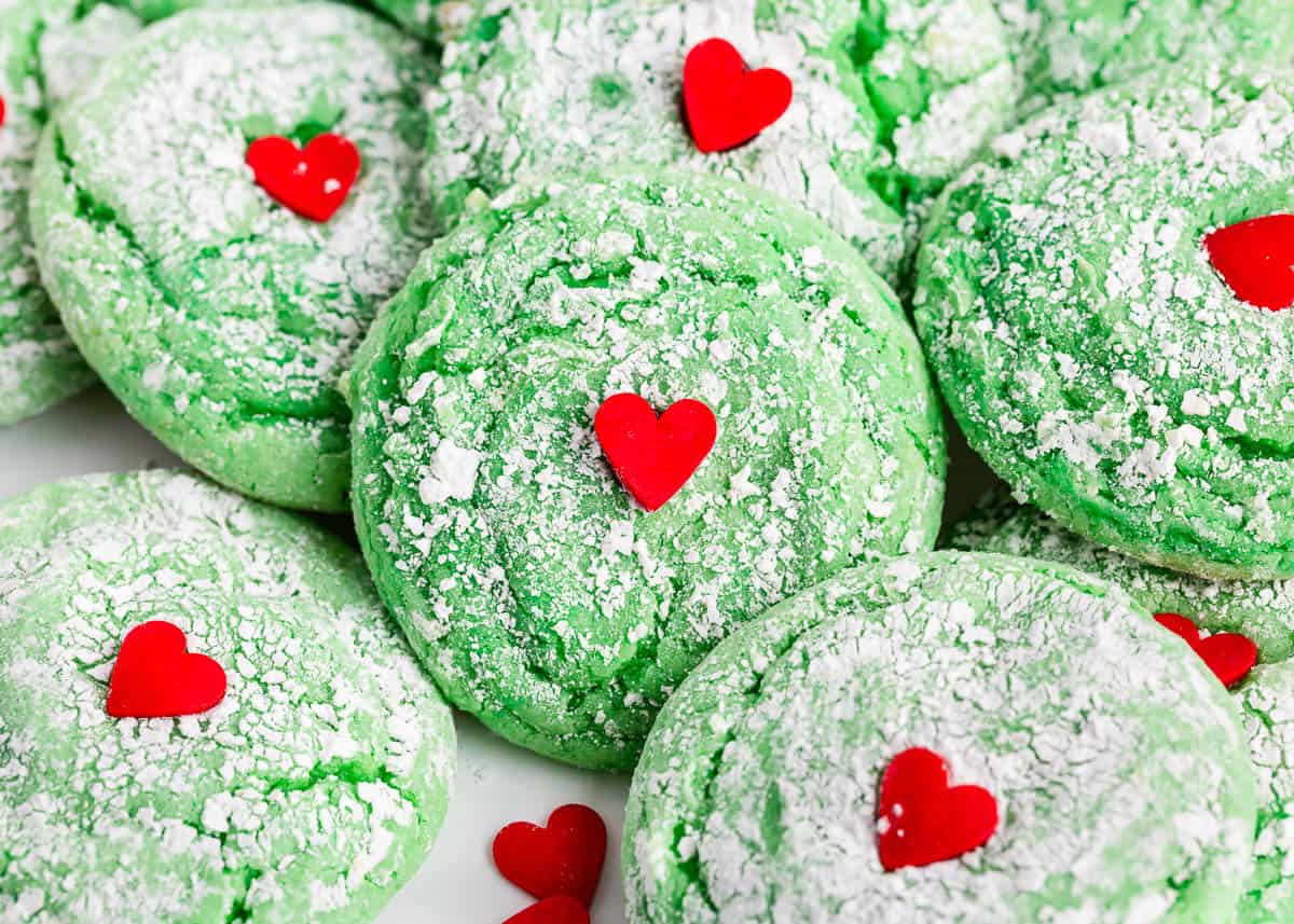 Grinch cookies with sprinkle hearts on top.
