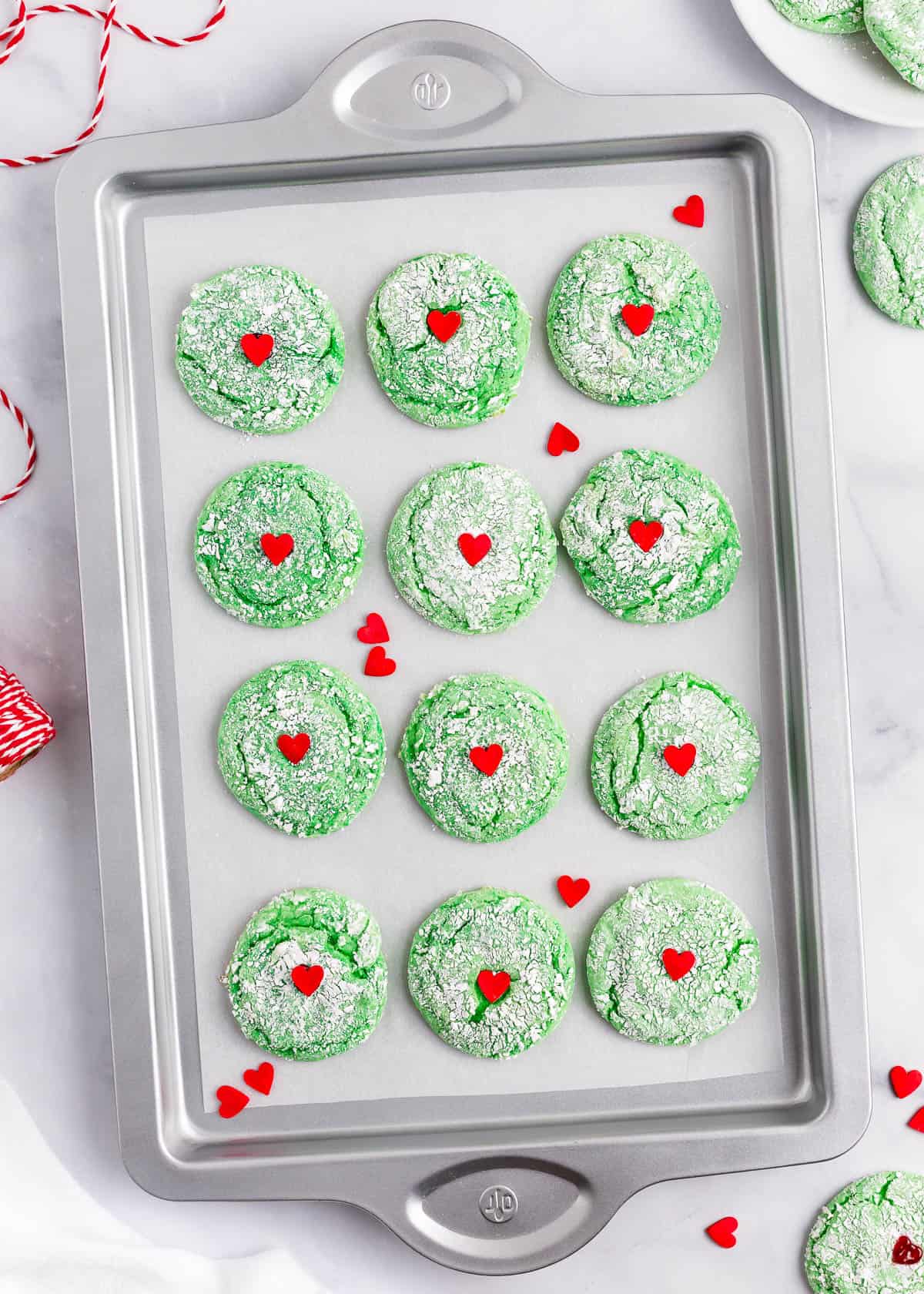 Grinch cookies on a baking sheet.