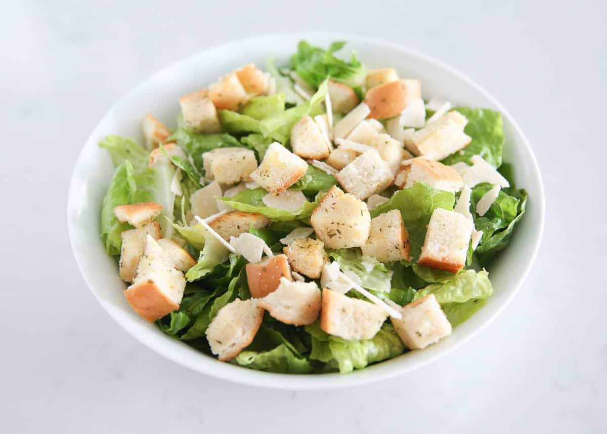 Caesar salad ingredients in a bowl.