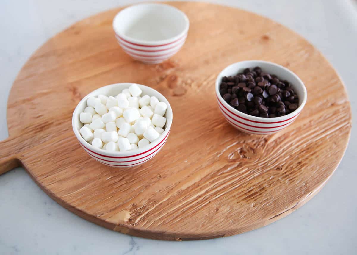 Ingredients for hot chocolate on a board.