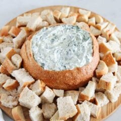 Knorr spinach dip and bread on a board.