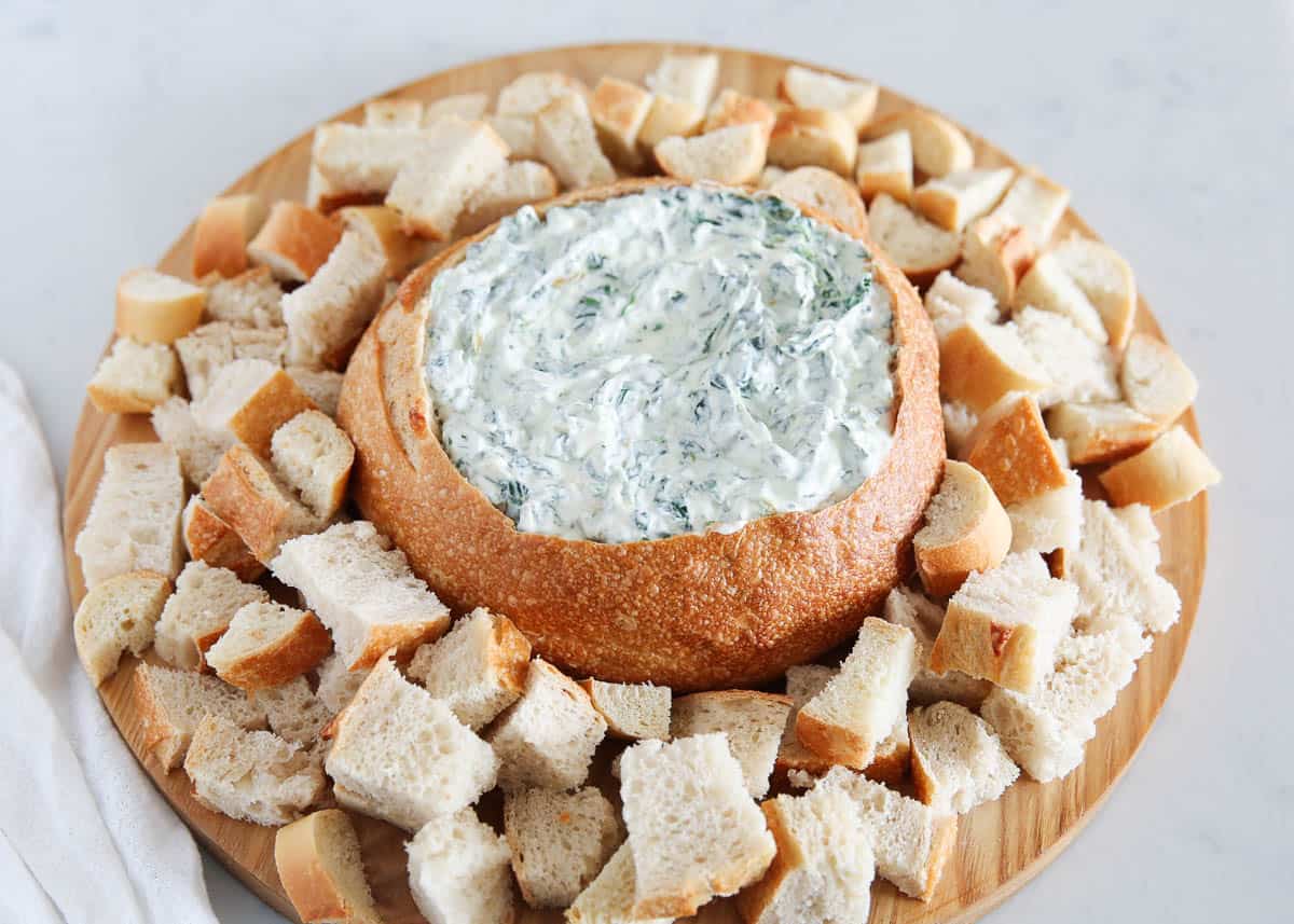 Knorr spinach dip and bread on a board.