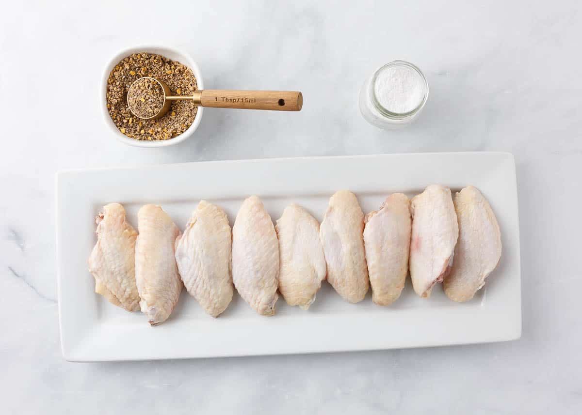 Lemon pepper wings ingredients on a white plate.