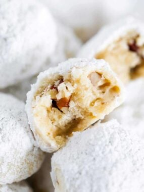 Mexican wedding cookies with a bite taken.