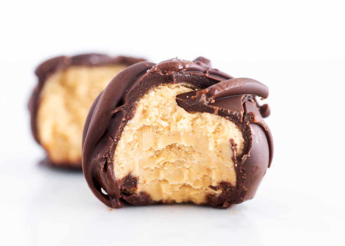 Peanut butter ball with chocolate on counter.