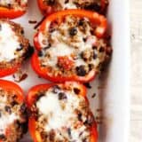Quinoa stuffed peppers in a baking dish.