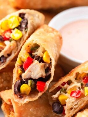 Southwest egg rolls sliced on white plate.