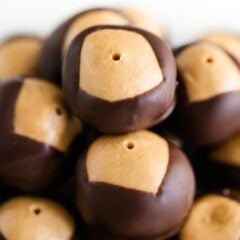 Buckeye candy recipe stacked on top of each other to show creamy peanut butter and chocolate coating.