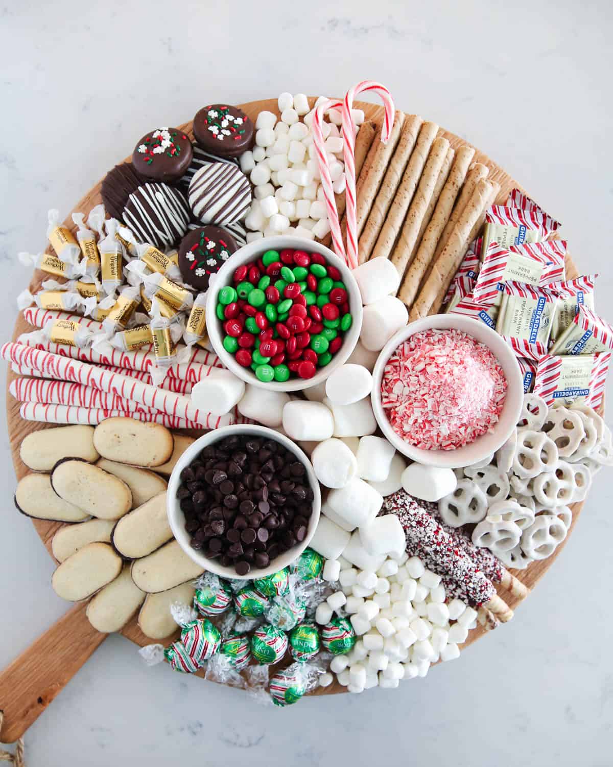 Hot chocolate charcuterie board on marble counter.