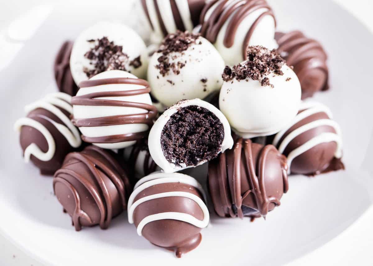 Oreo balls on a white plate with a bite taken.