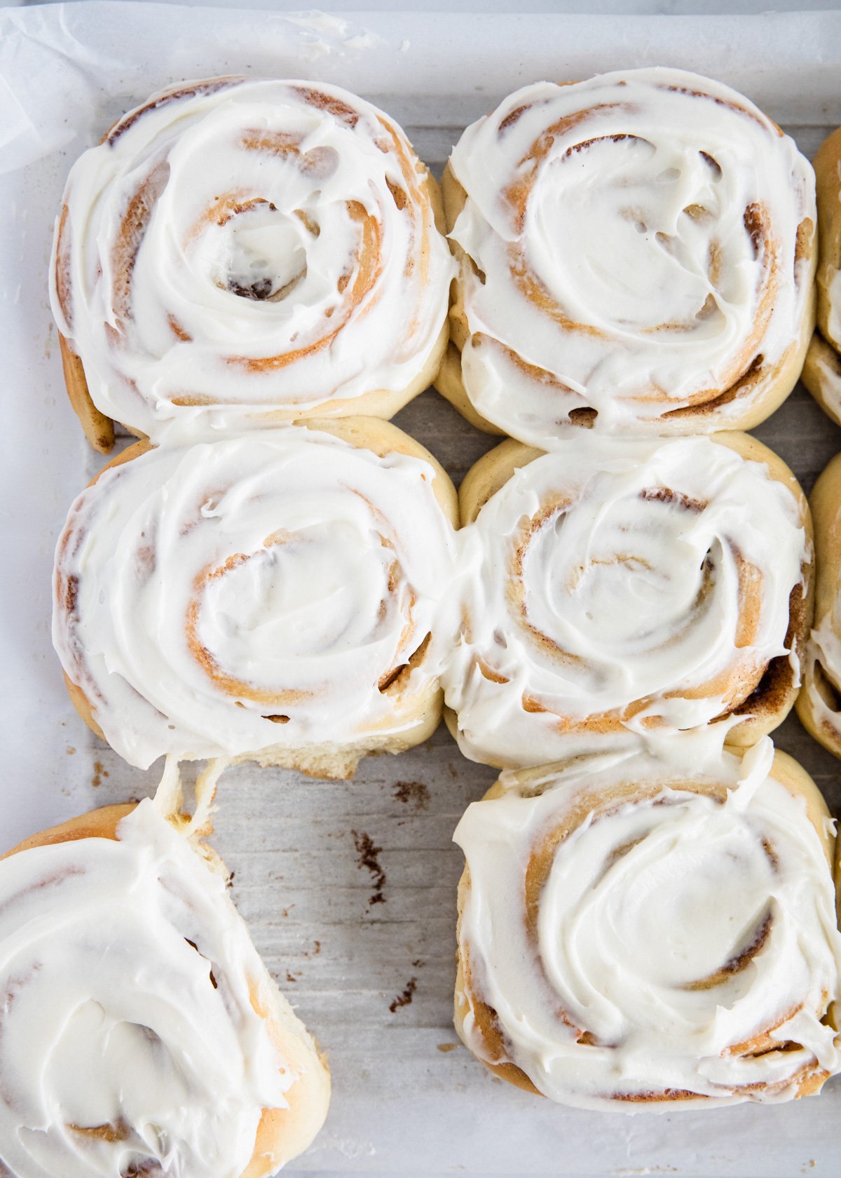 Overhead photo shot of cinnamon rolls with frosting. 