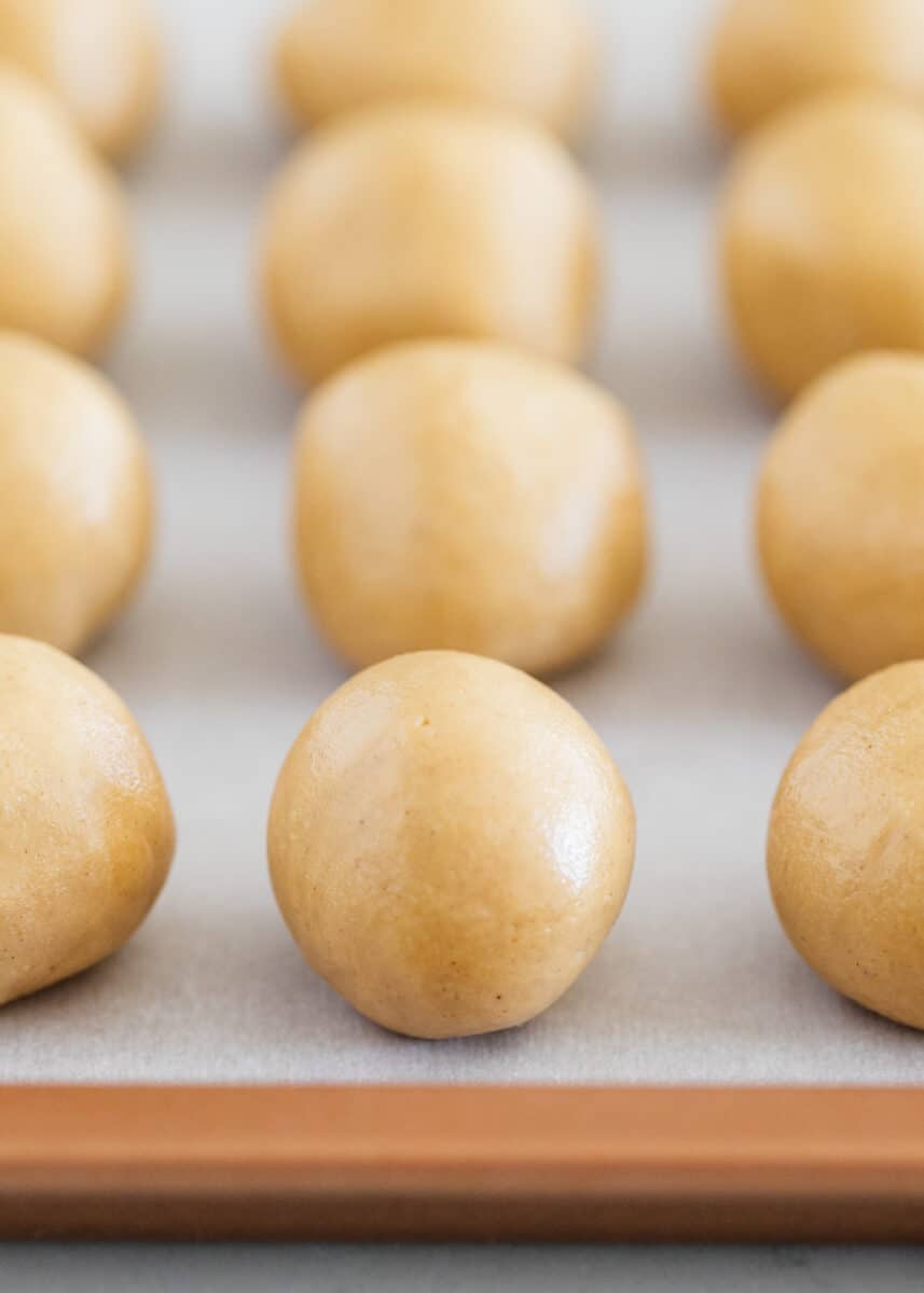 Peanut butter balls on a baking sheet.