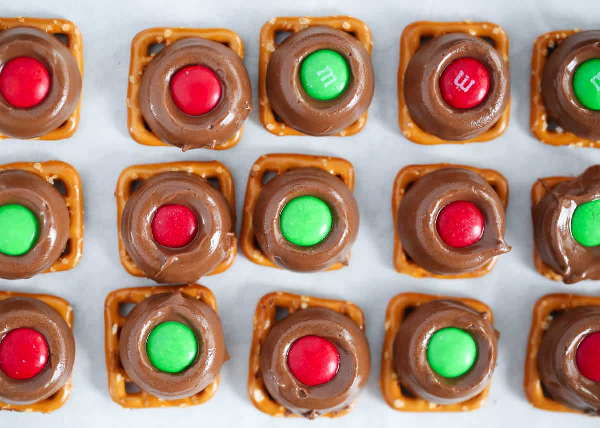 Only 3 ingredients to make and the perfect blend of salty and sweet, crunchy and chewy, and all around delicious! These Rolo pretzels are the easiest holiday treat and are so fun and festive Rolo pretzels on a pan.