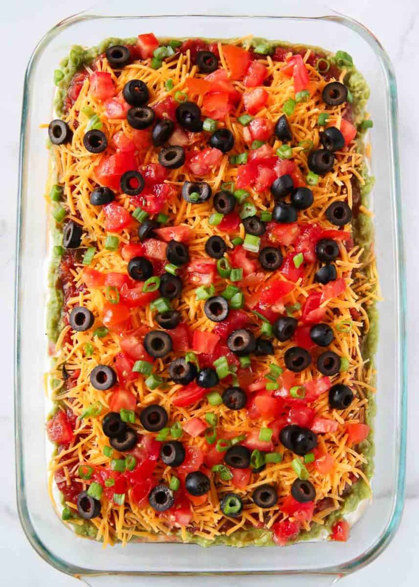 Seven layer dip in a glass baking dish.