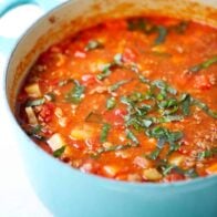 Vegetable beef soup in a blue pot.