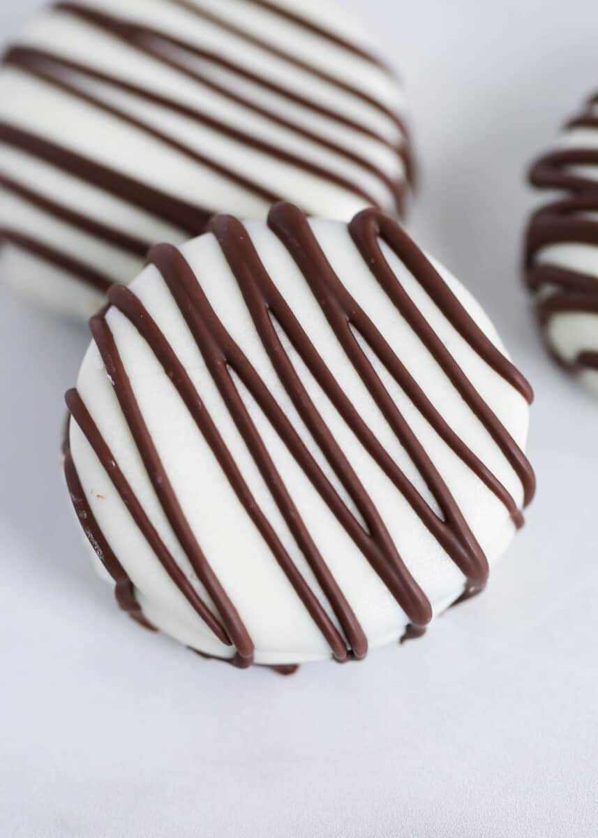 White chocolate covered oreos on a dish. 