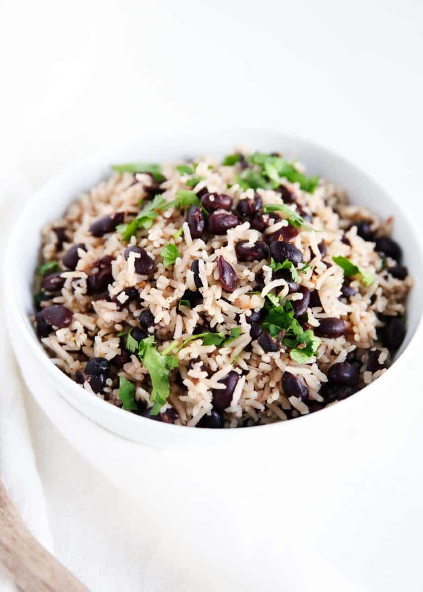 Black beans and rice in a white bowl with cilantro.