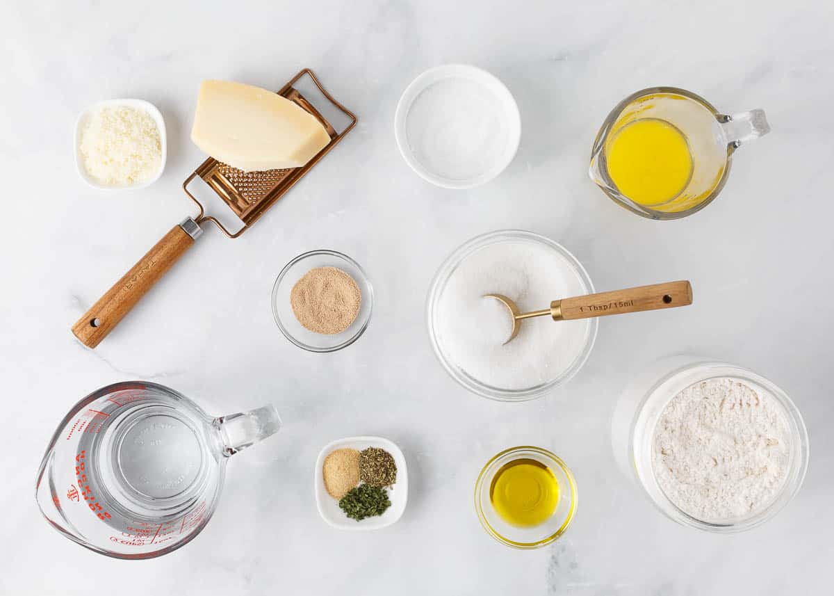 Breadsticks ingredients on marble counter.