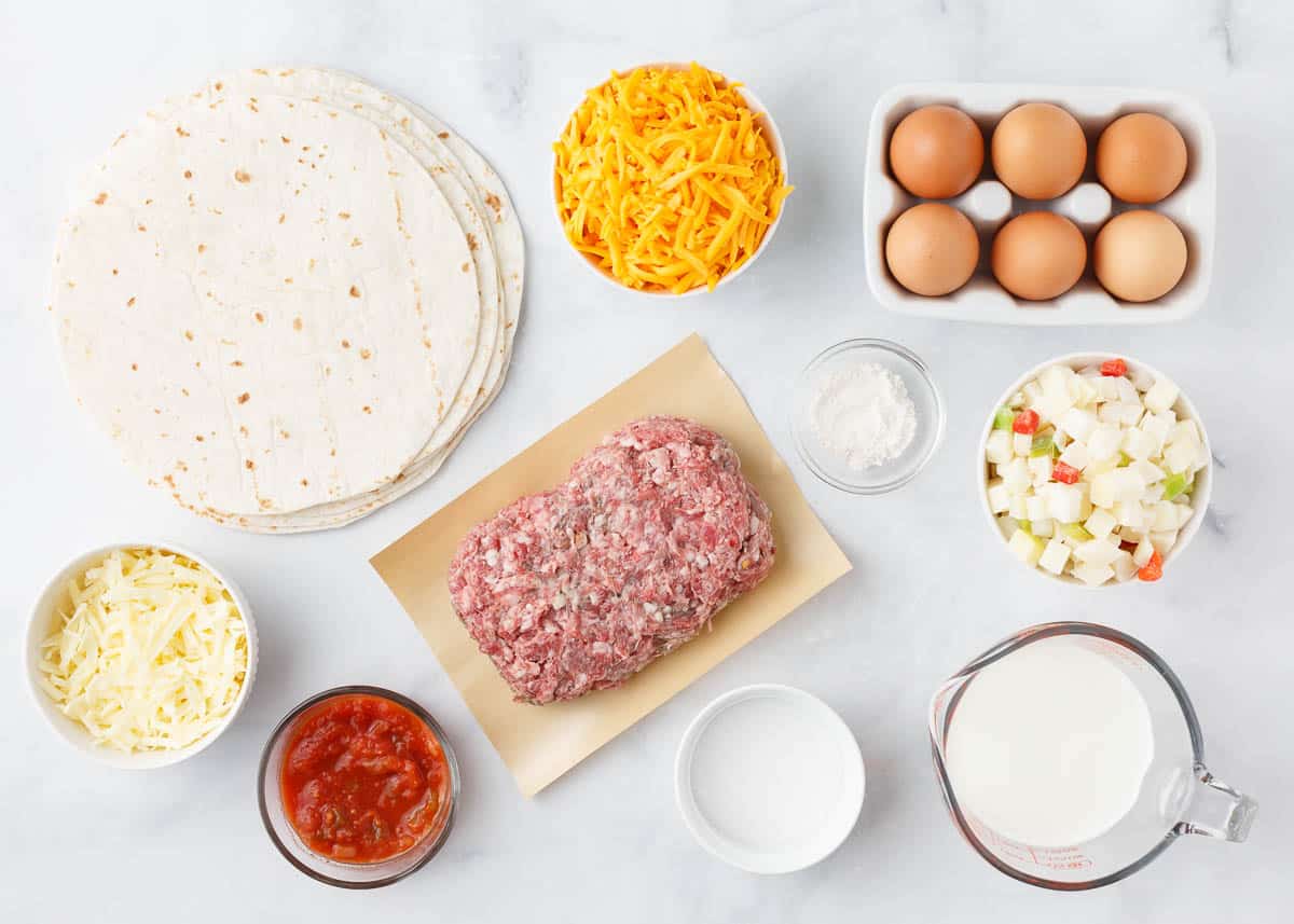 Breakfast enchiladas ingredients on counter.