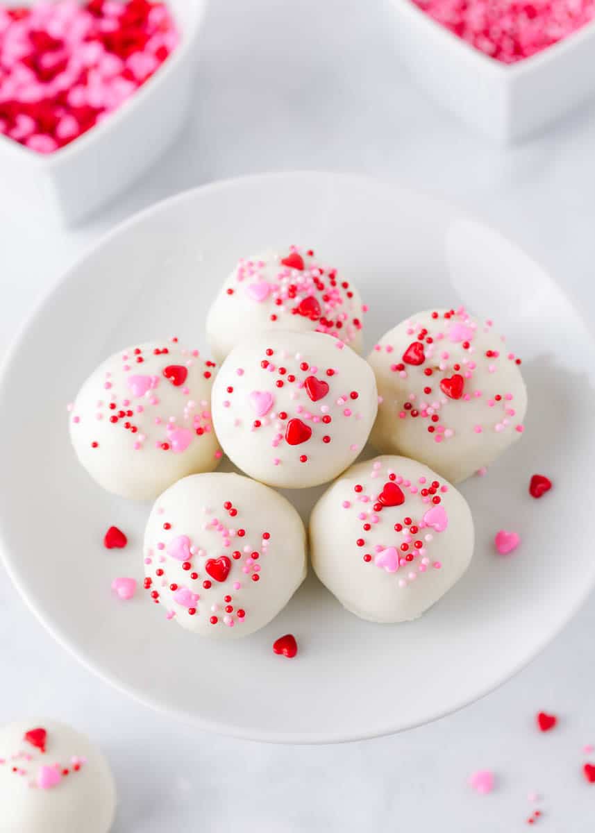 Cake balls with Valentine sprinkles on plate.