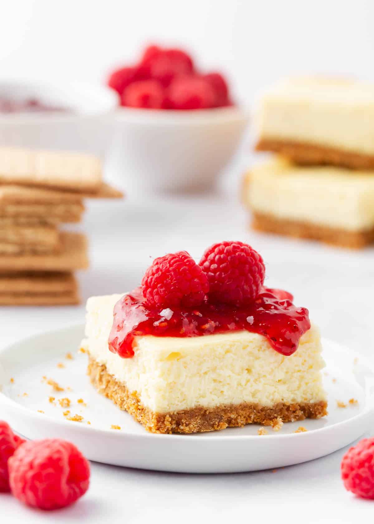 Cheesecake bars with fresh raspberries on top.