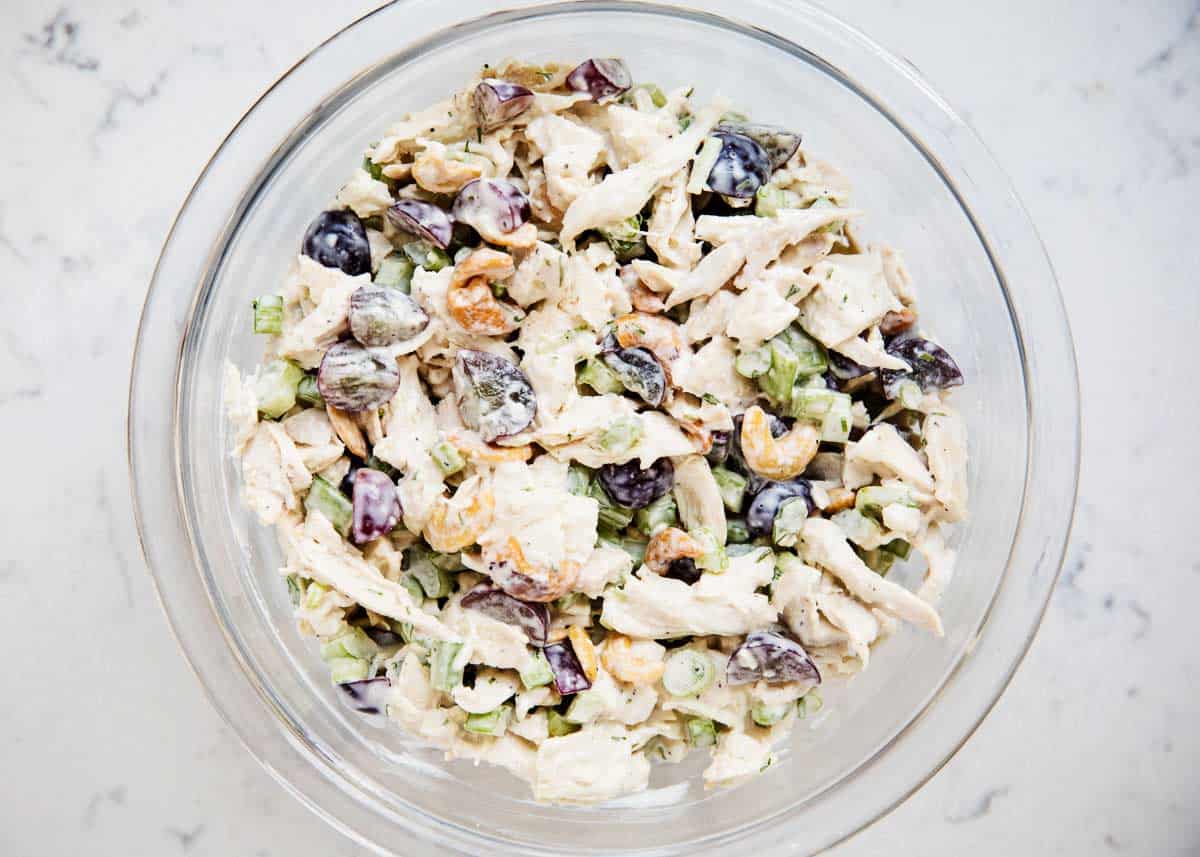 Chicken salad mixture in a glass bowl. 