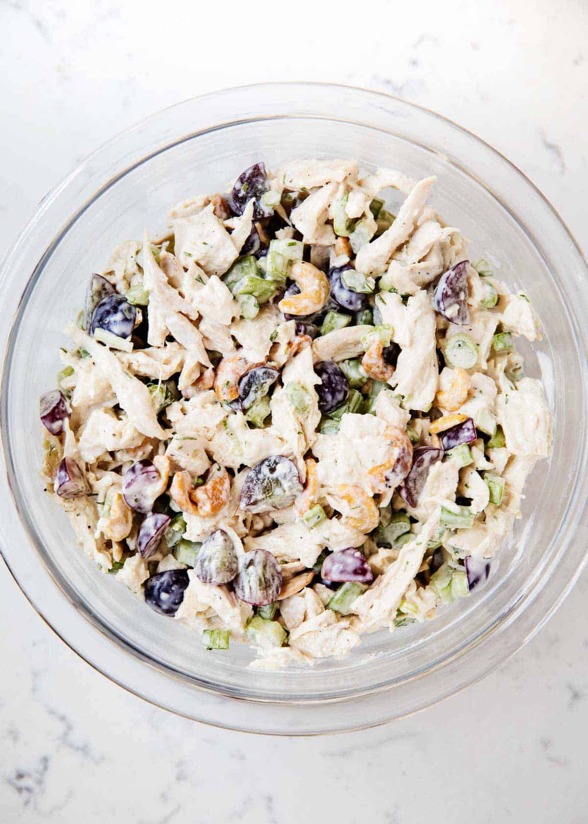 Overhead shot of the chicken salad mixture in a glass bowl. 