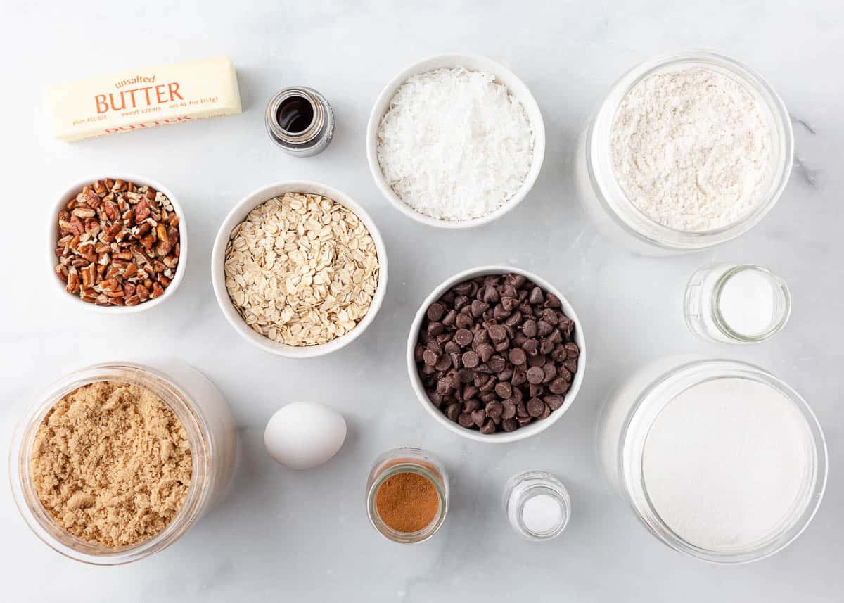 Cowboy cookie ingredients on marble counter.