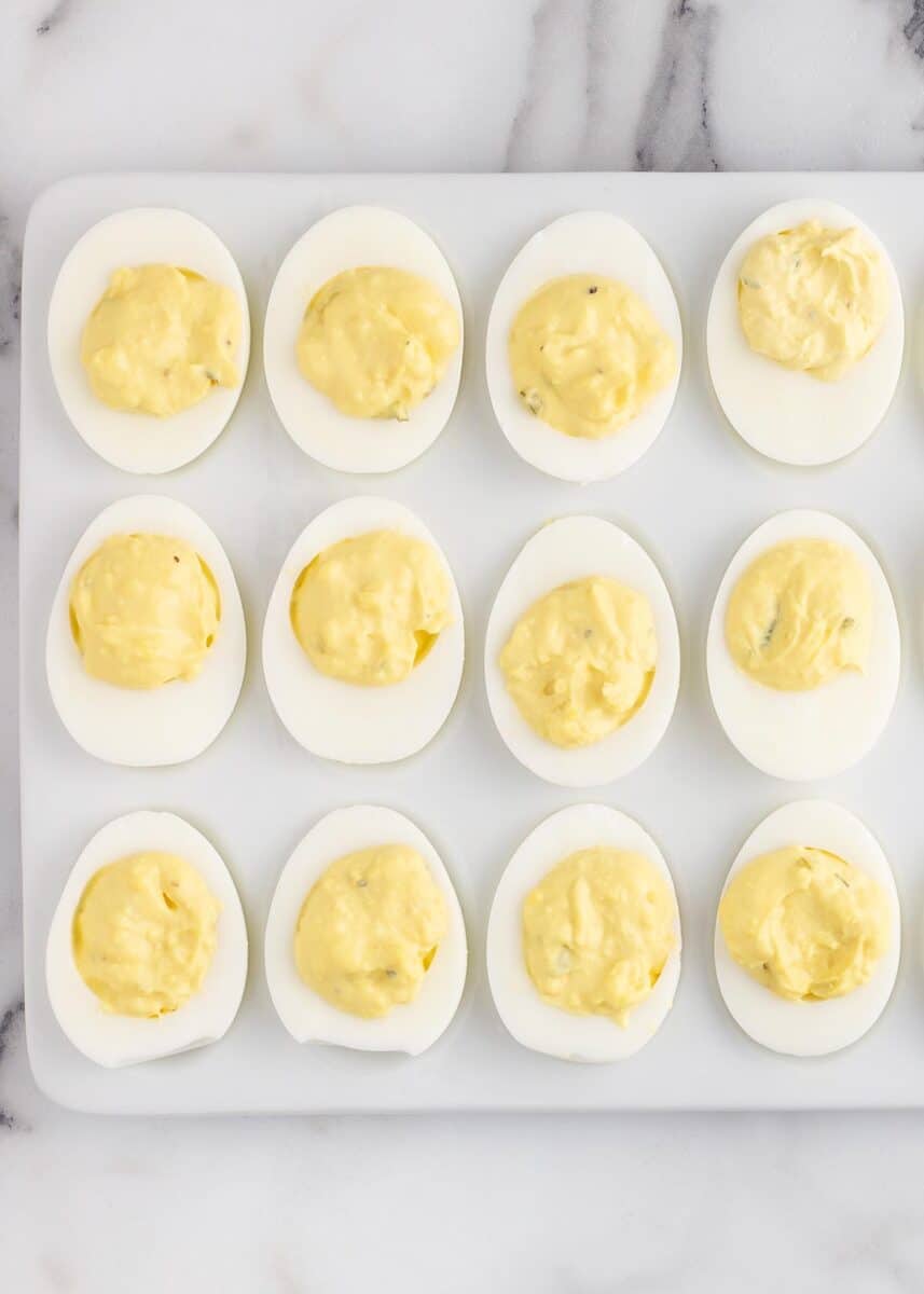 Deviled eggs on a white platter.