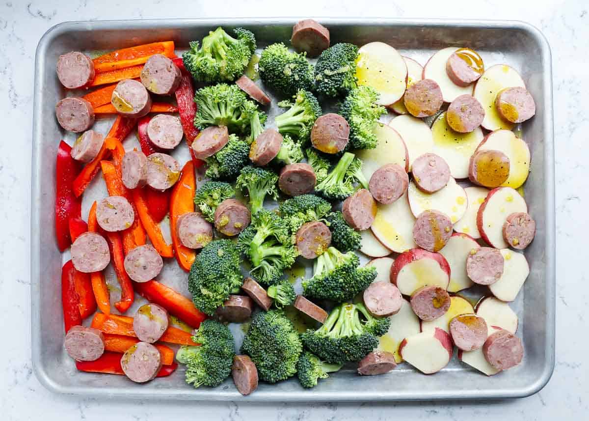 Showing how to make sausage and veggies on a sheet pan.