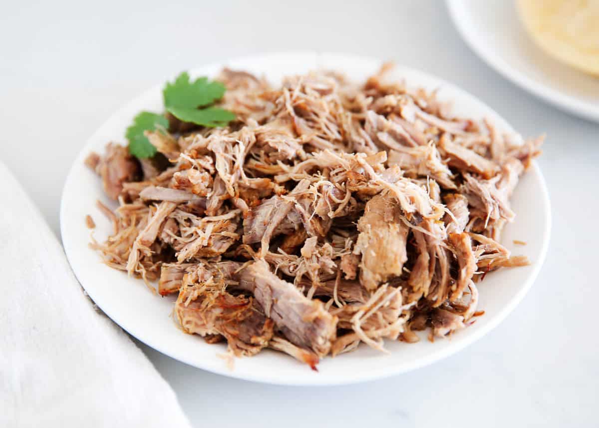 Instant pot carnitas on a white plate.