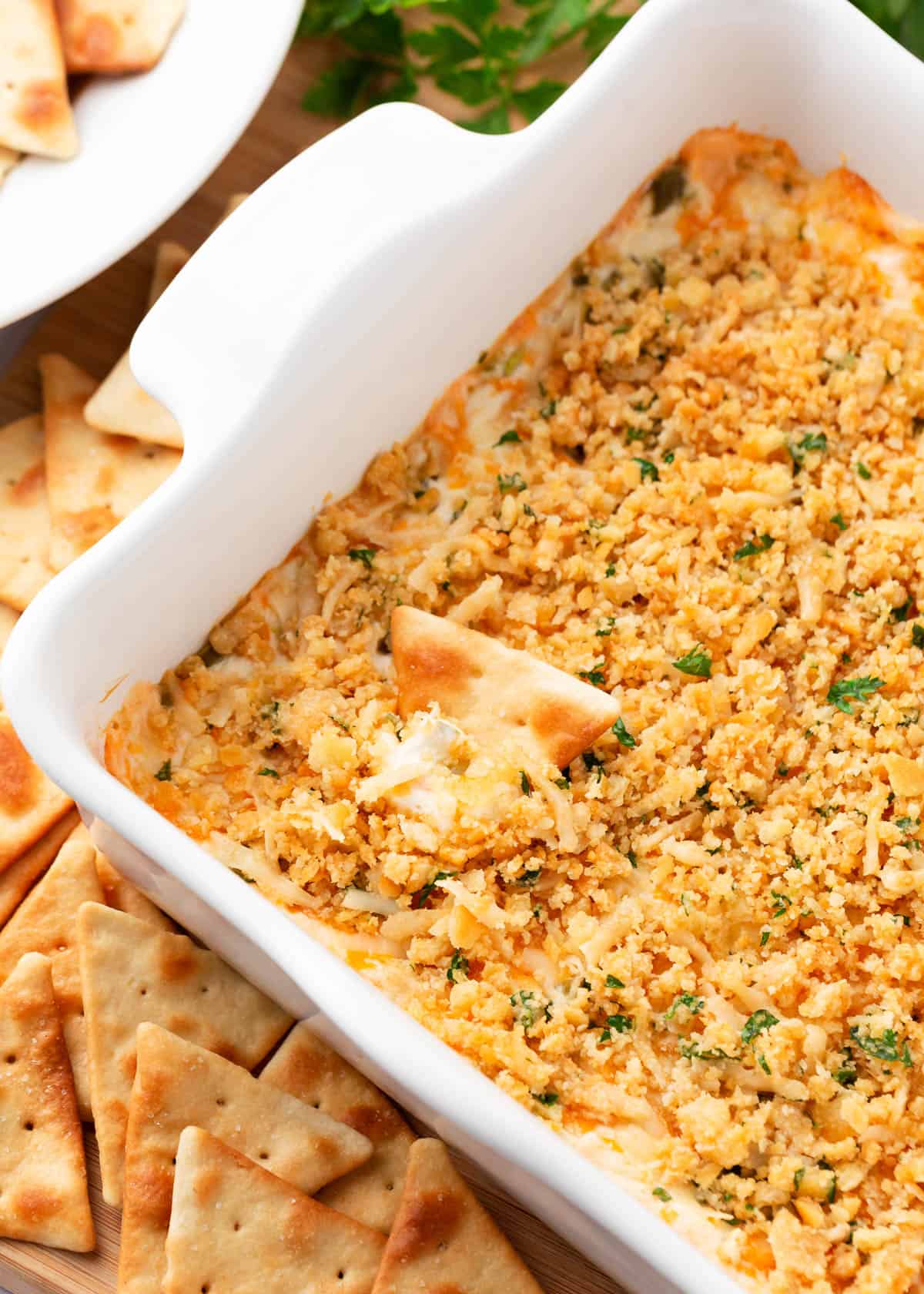 Jalapeno popper dip with a pita chip.