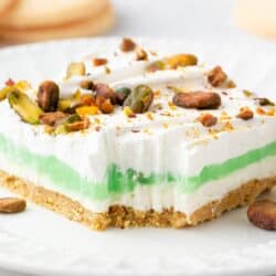 Layered pistachio dessert on plate.