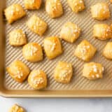 Pretzel bites on gold baking sheet.