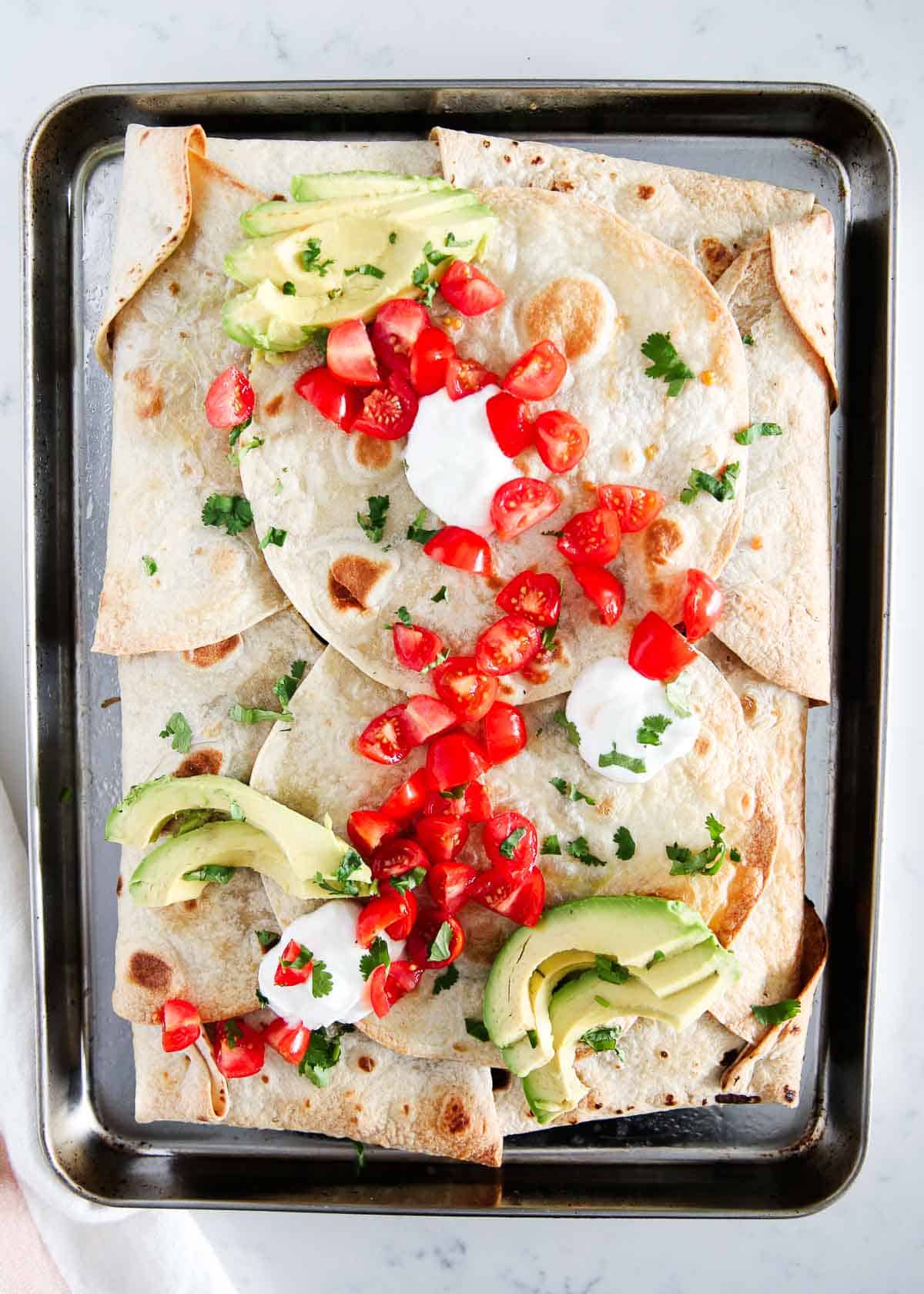 Sheet pan quesadilla on a metal baking sheet.