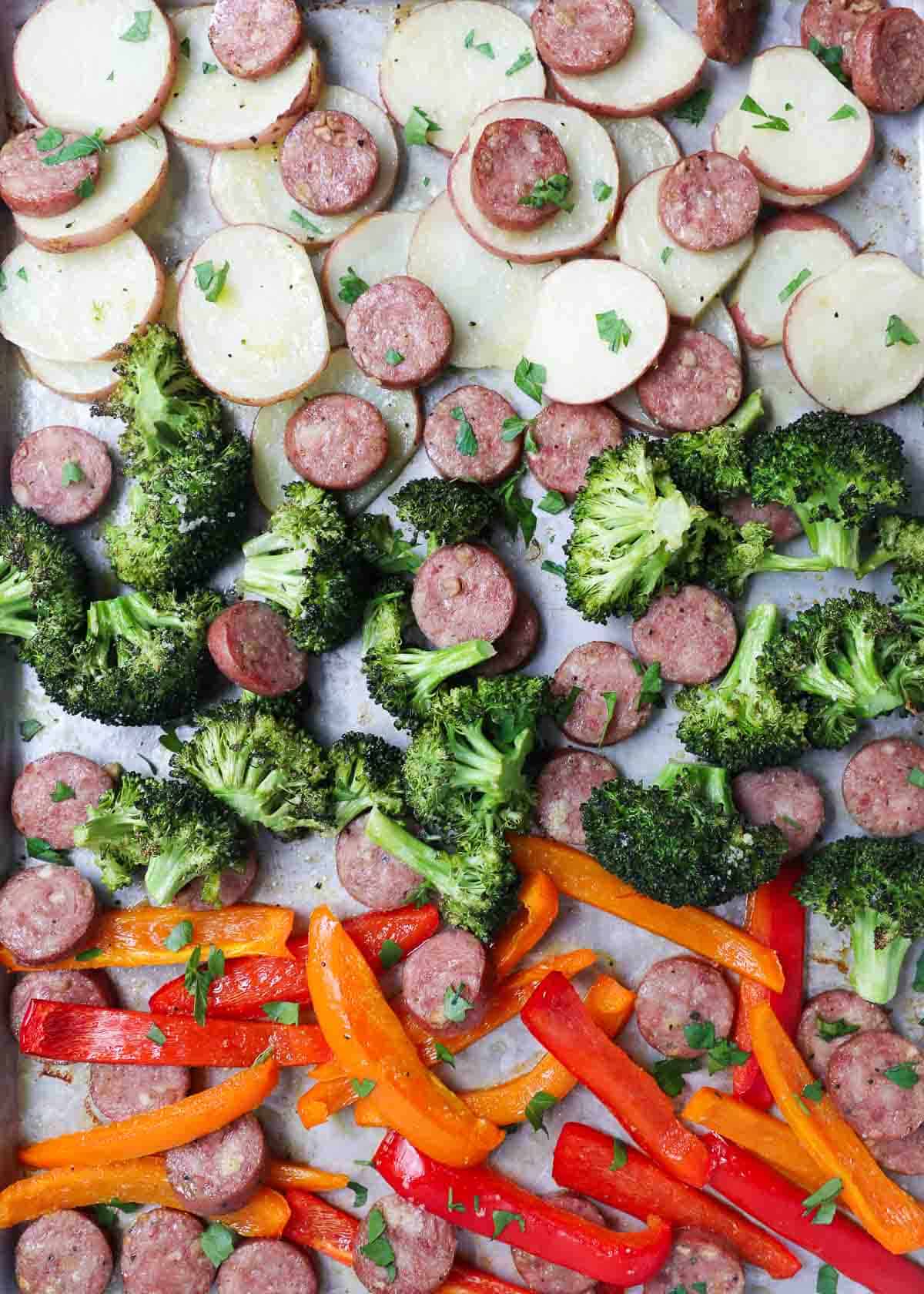 Sheet pan sausage and veggies on a sheet pan.