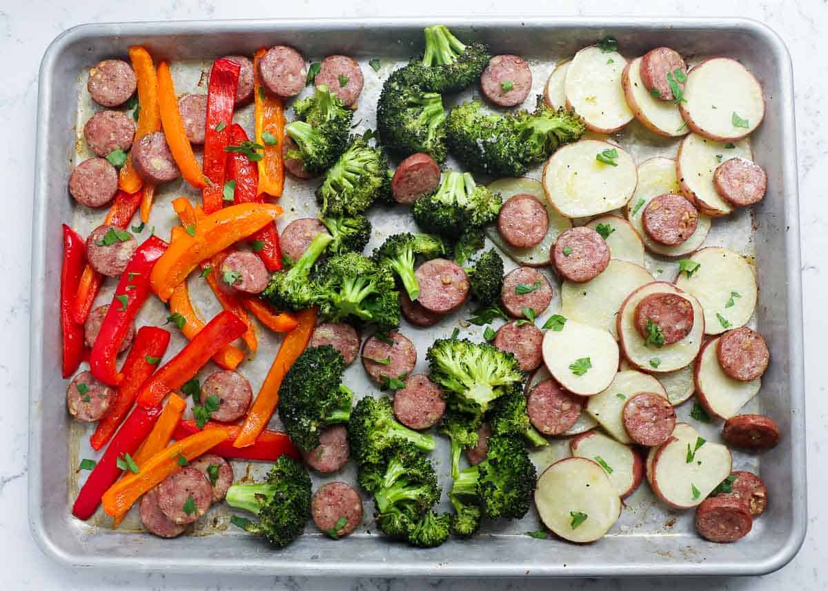 Sheet pan sausage and veggies on a sheet pan.