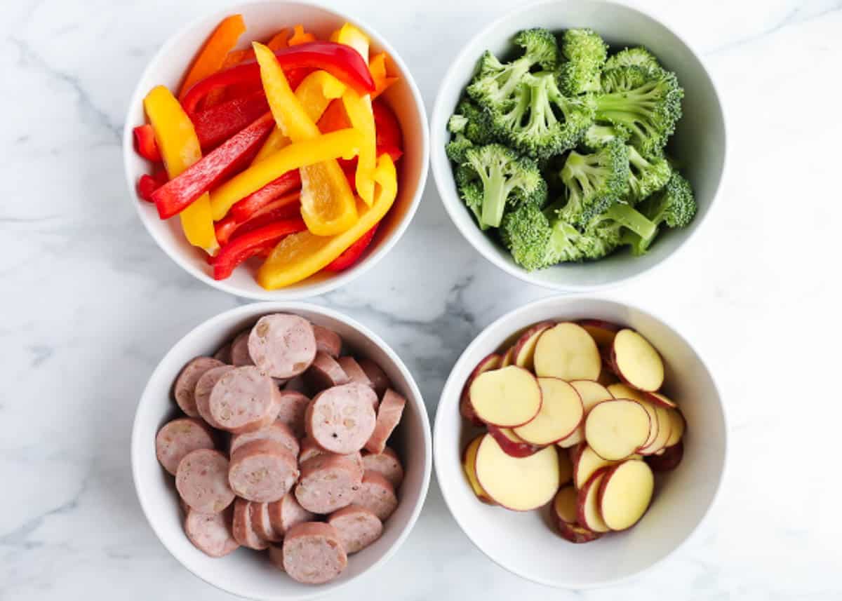 Sheet pan sausage and veggies ingredients on counter.